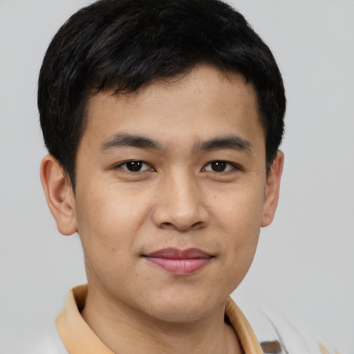 Joyful latino young-adult male with short  brown hair and brown eyes