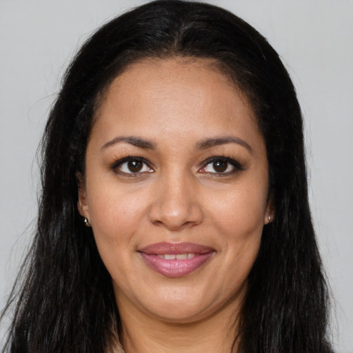 Joyful latino young-adult female with long  brown hair and brown eyes