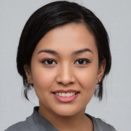 Joyful asian young-adult female with medium  black hair and brown eyes