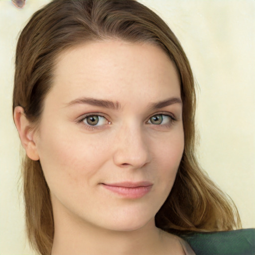 Joyful white young-adult female with long  brown hair and green eyes