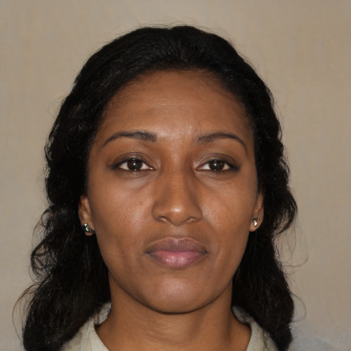 Joyful black adult female with medium  black hair and brown eyes