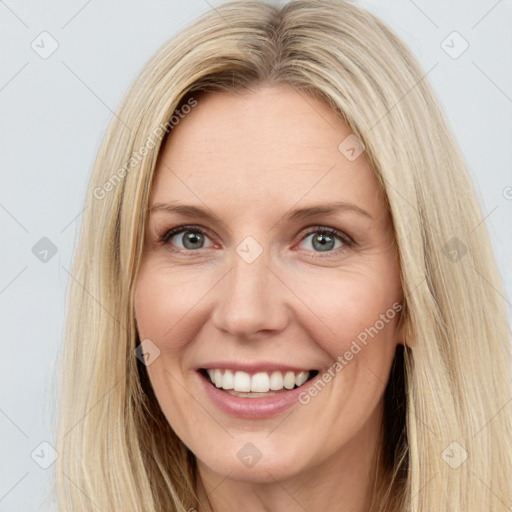 Joyful white young-adult female with long  brown hair and blue eyes