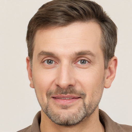 Joyful white adult male with short  brown hair and brown eyes