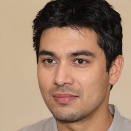 Joyful white young-adult male with short  black hair and brown eyes