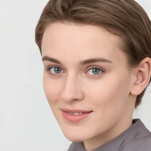 Joyful white young-adult female with short  brown hair and blue eyes