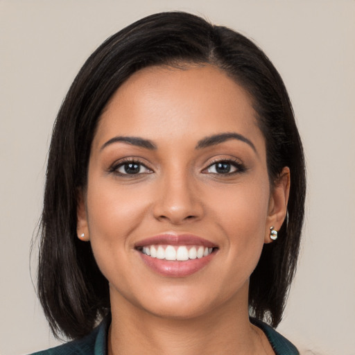 Joyful latino young-adult female with long  black hair and brown eyes