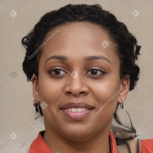 Joyful black young-adult female with long  brown hair and brown eyes