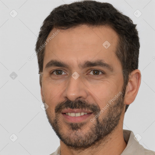 Joyful white adult male with short  brown hair and brown eyes