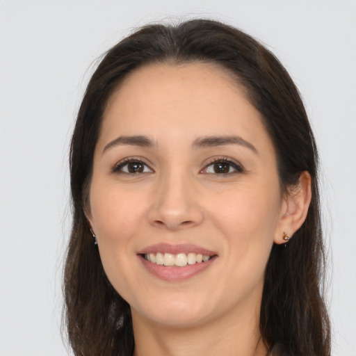 Joyful white young-adult female with long  brown hair and brown eyes