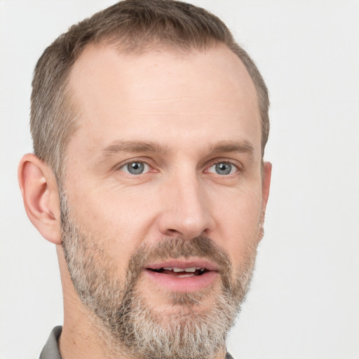 Joyful white adult male with short  brown hair and grey eyes