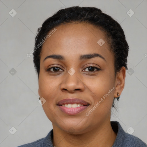 Joyful black young-adult female with short  black hair and brown eyes