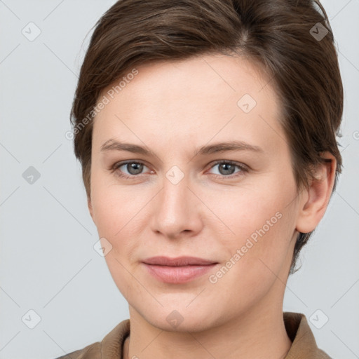 Joyful white young-adult female with short  brown hair and grey eyes