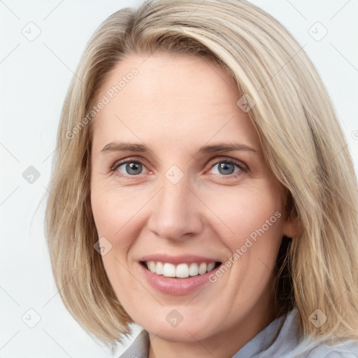 Joyful white young-adult female with medium  brown hair and blue eyes