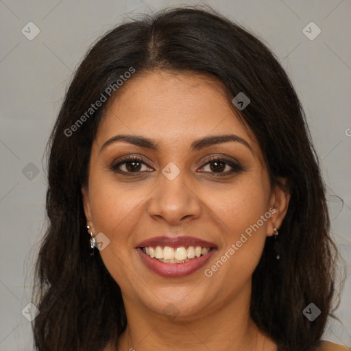 Joyful black young-adult female with long  brown hair and brown eyes