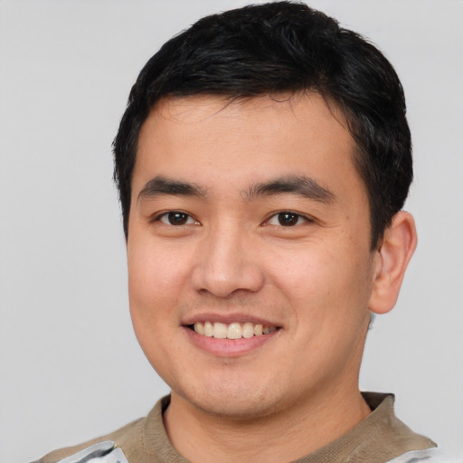 Joyful asian young-adult male with short  black hair and brown eyes