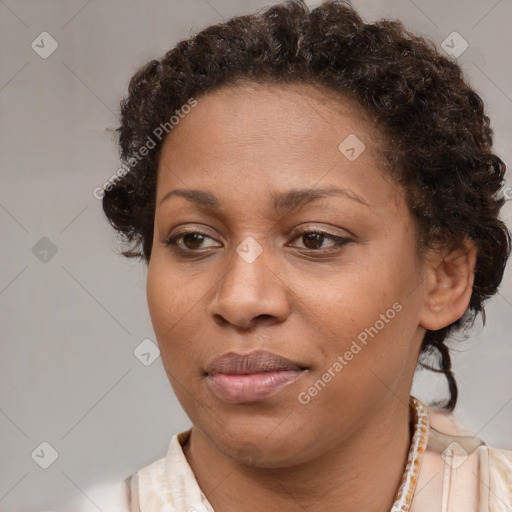 Joyful black adult female with short  brown hair and brown eyes