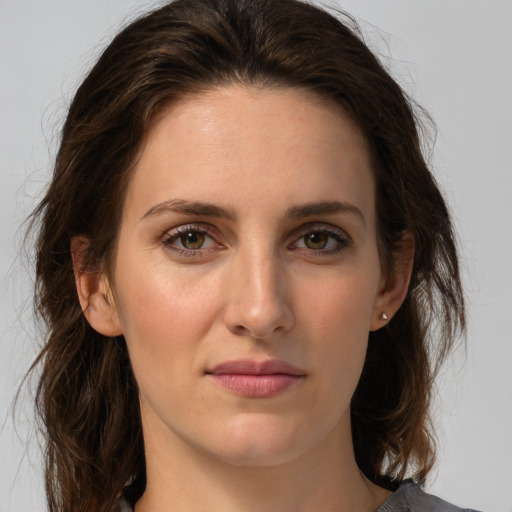 Joyful white young-adult female with medium  brown hair and green eyes