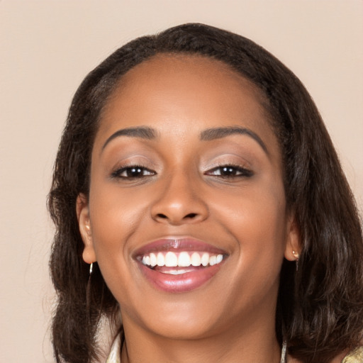 Joyful latino young-adult female with medium  brown hair and brown eyes