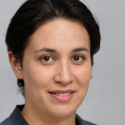 Joyful white adult female with medium  brown hair and brown eyes