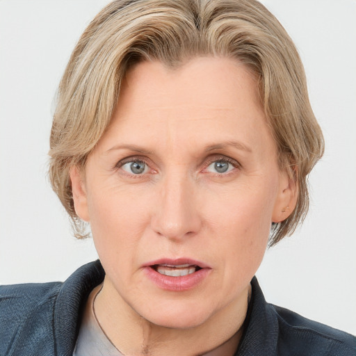 Joyful white adult female with medium  brown hair and blue eyes