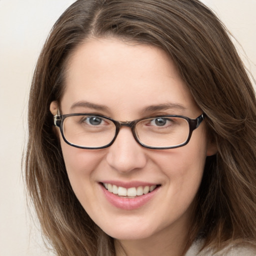 Joyful white young-adult female with long  brown hair and grey eyes