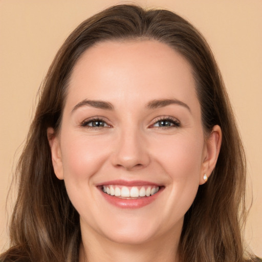 Joyful white young-adult female with long  brown hair and brown eyes