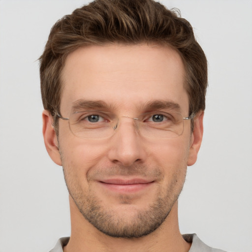 Joyful white adult male with short  brown hair and grey eyes