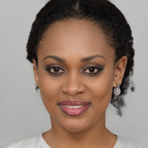 Joyful black young-adult female with short  black hair and brown eyes