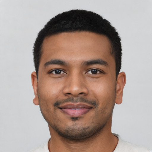 Joyful latino young-adult male with short  black hair and brown eyes