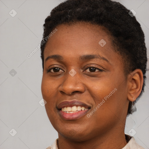 Joyful black young-adult female with short  black hair and brown eyes