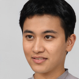 Joyful asian young-adult male with short  black hair and brown eyes