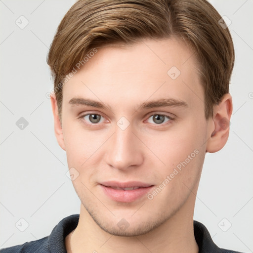 Joyful white young-adult male with short  brown hair and grey eyes