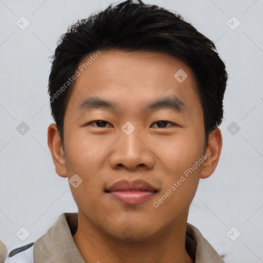 Joyful asian young-adult male with short  black hair and brown eyes