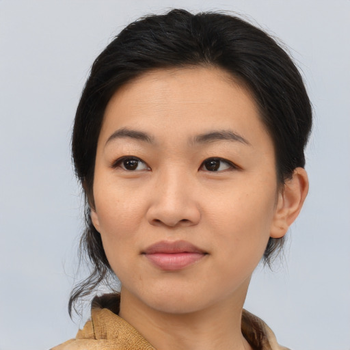 Joyful asian young-adult female with medium  brown hair and brown eyes