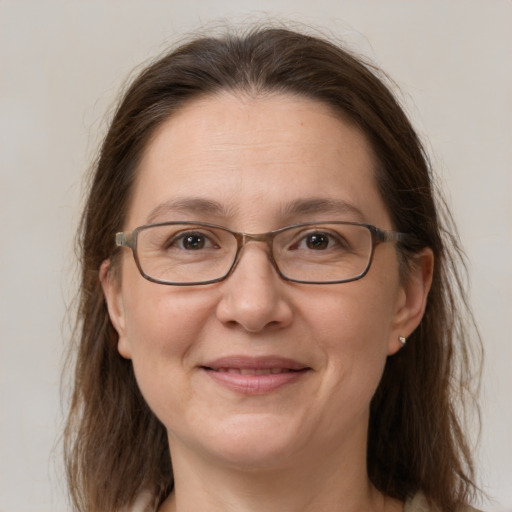 Joyful white adult female with medium  brown hair and grey eyes