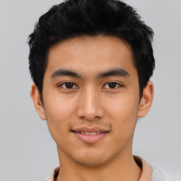 Joyful asian young-adult male with short  black hair and brown eyes