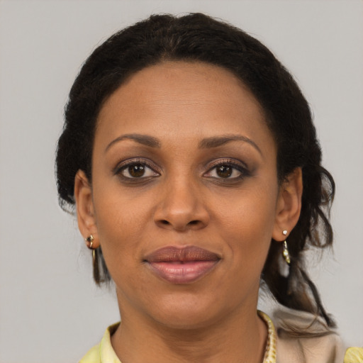 Joyful black adult female with short  brown hair and brown eyes