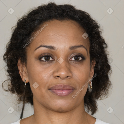 Joyful black adult female with medium  brown hair and brown eyes