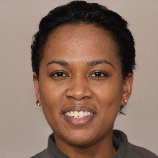 Joyful latino young-adult female with short  black hair and brown eyes