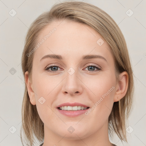 Joyful white young-adult female with medium  brown hair and blue eyes