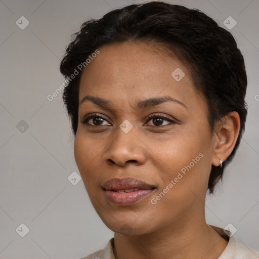 Joyful black young-adult female with short  black hair and brown eyes