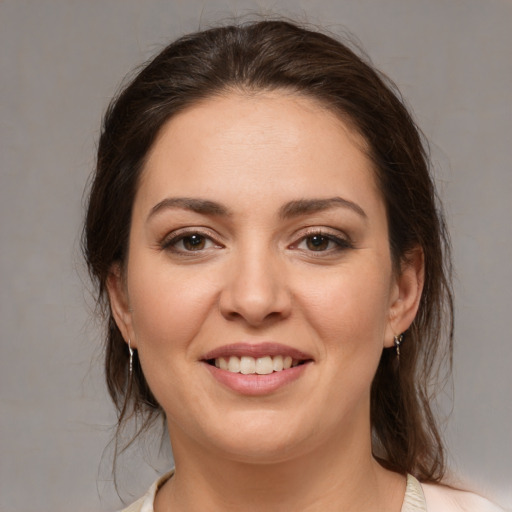 Joyful white young-adult female with medium  brown hair and brown eyes