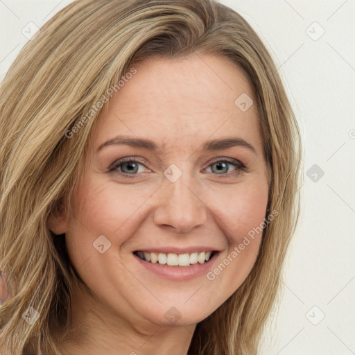 Joyful white adult female with long  brown hair and green eyes