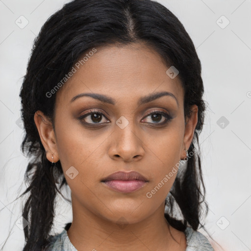 Joyful black young-adult female with long  brown hair and brown eyes