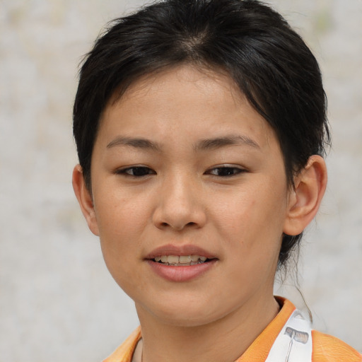 Joyful asian young-adult female with short  brown hair and brown eyes
