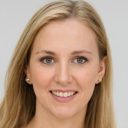 Joyful white young-adult female with long  brown hair and green eyes