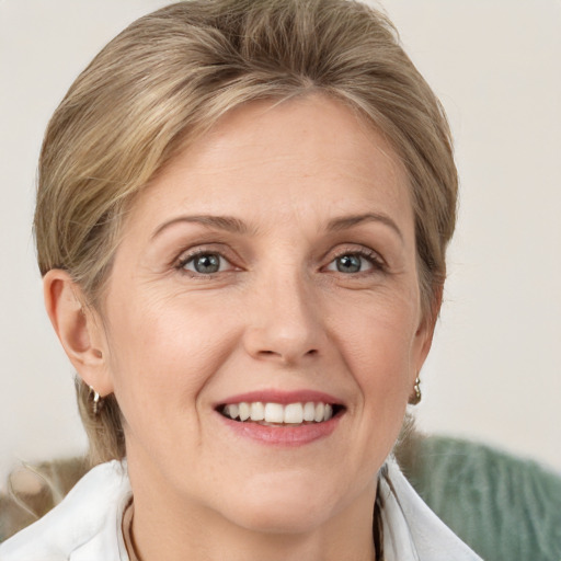 Joyful white adult female with medium  brown hair and grey eyes