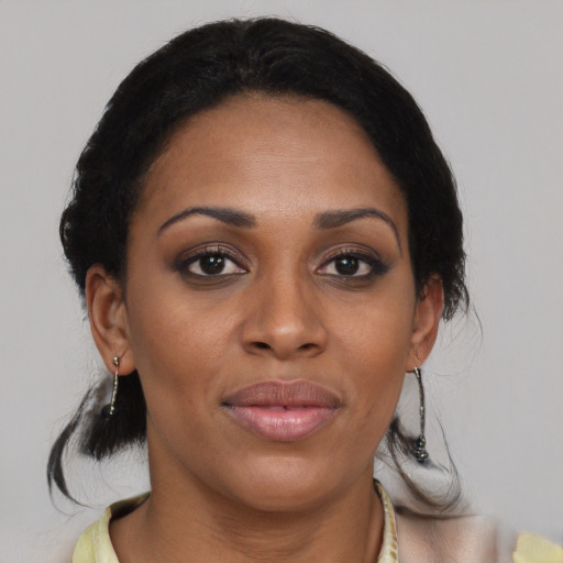 Joyful black young-adult female with medium  brown hair and brown eyes
