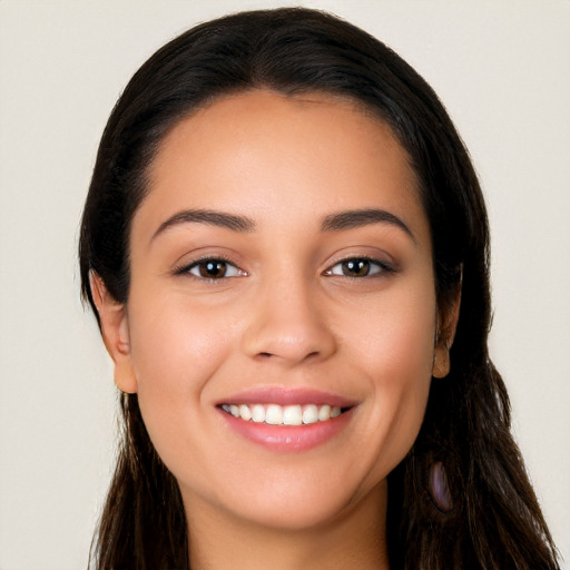 Joyful white young-adult female with long  brown hair and brown eyes