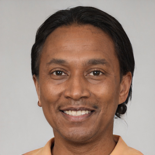 Joyful latino adult male with short  black hair and brown eyes
